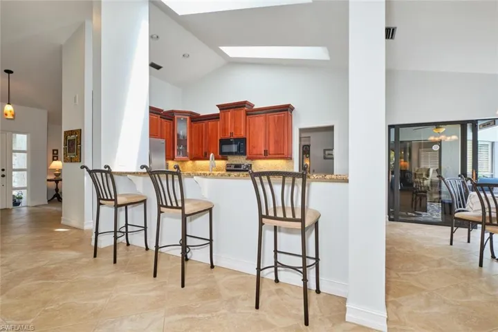Kitchen features a large breakfast bar area.