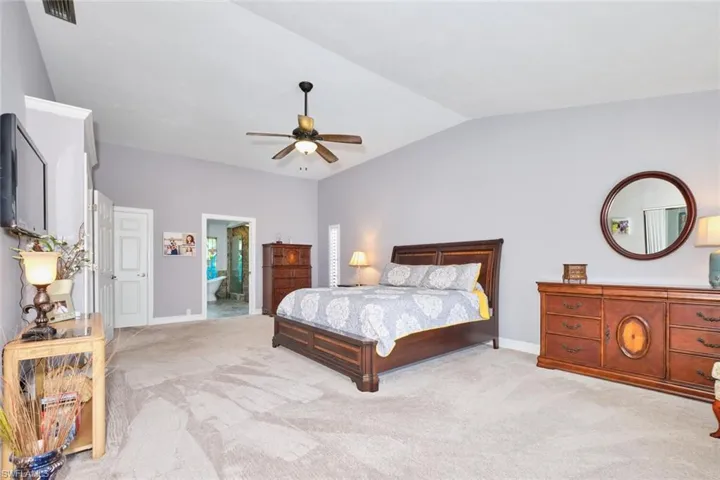 Super spacious master suite with lighted ceiling fan and vaulted ceiling.