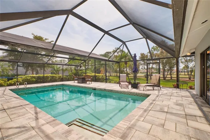 Large pool with paver deck and expansive golf course views.