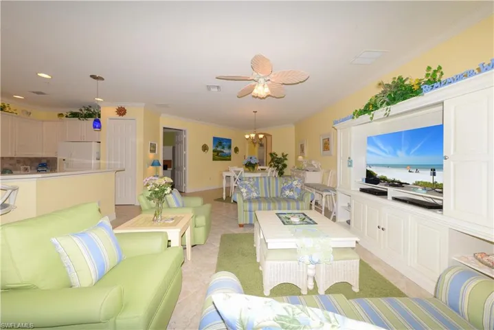 Spacious Great-room looking toward the Dining room and Entry Foyer. Features 20" diagonal tile flooring, 10' ceilings, 8' doorways, Crown molding & more!