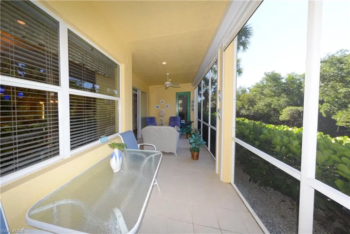 Large Lanai with tranquil natural Creek and Preserve views. Features Tiled floor & electric roll down mesh style Hurricane shutters.