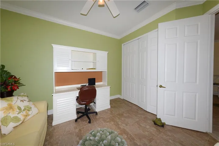 Spacious Guest bedroom features 20" tile flooring, crown molding, ample closet space, ceiling fan with light kit and window blinds.