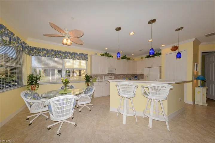 Spacious open Kitchen, Breakfast nook & Breakfast bar featuring 10' ceilings, recessed & pendant lighting, Crown molding, 42" upper cabinets & soft close drawers.