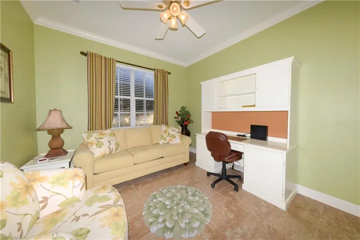 Spacious Guest bedroom features 20" tile flooring, crown molding, ample closet space, ceiling fan with light kit and window blinds.