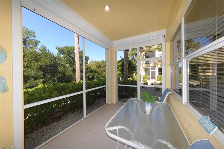 Large Lanai with tranquil natural Creek and Preserve views. Features Tiled floor & electric roll down mesh style Hurricane shutters.