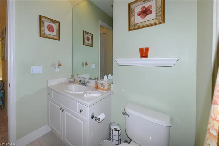 Guest bathroom features full tub and shower with upgraded tile walls in shower and shampoo niche & tile floors.