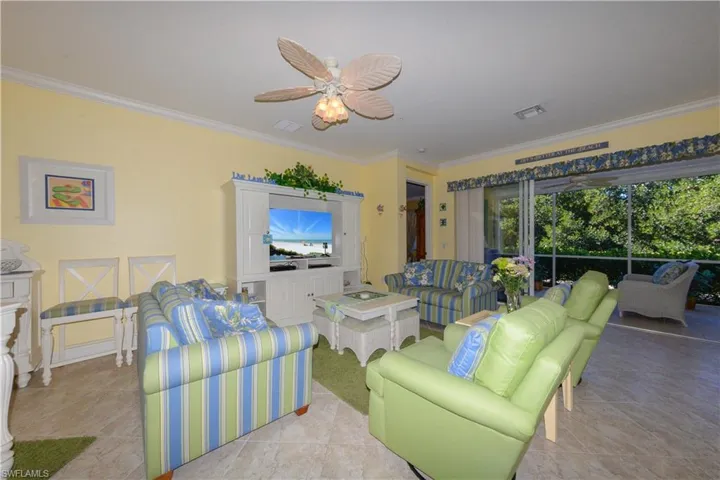 Spacious Open Great-Room featuring Crown molding, 20" diagonal tile flooring, 10' ceilings, 8' doorways, triple sliding glass doors leading to the large Lanai and Tranquil Views of the natural Creek and Preserve.