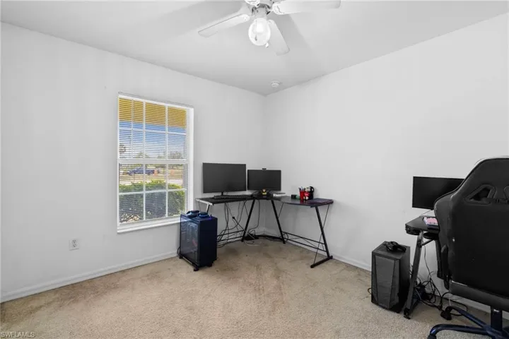 Unfurnished room with vaulted ceiling, carpet floors, and ceiling fan