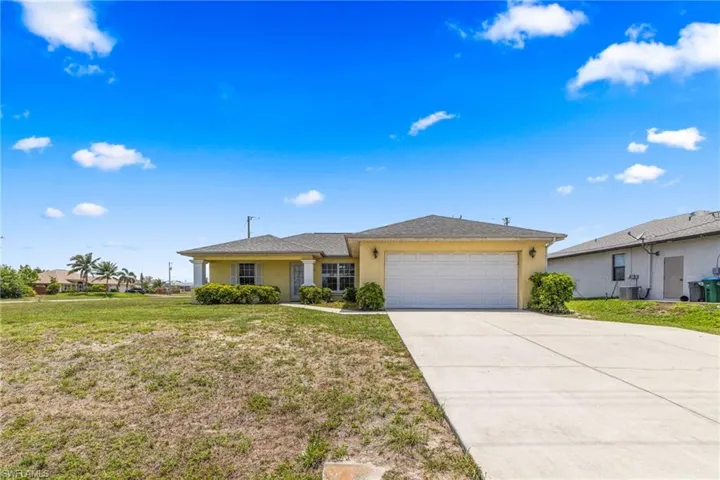Ranch-style home with stucco siding, an attached garage, concrete driveway, a front yard, and roof with shingles