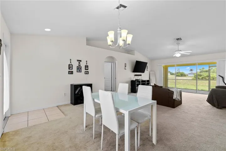 Carpeted spare room featuring a ceiling fan and baseboards