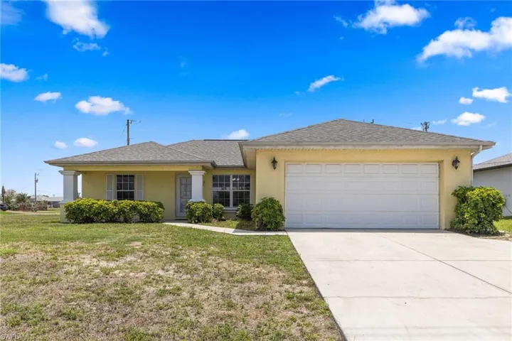 Ranch-style house featuring stucco siding, an attached garage, concrete driveway, a front lawn, and a shingled roof