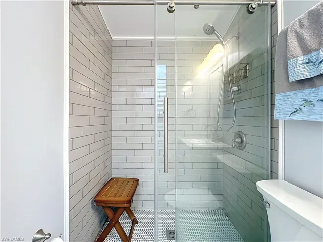 Bathroom featuring a stall shower and toilet