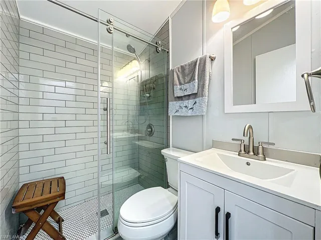 Full bathroom with a stall shower and vanity