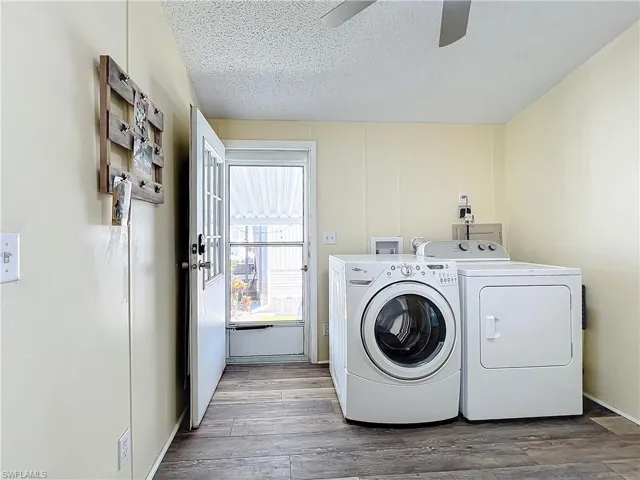 Laundry room featuring a textured ceiling, and washer and dryer