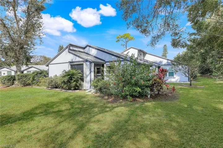 Rear view of property featuring a lawn