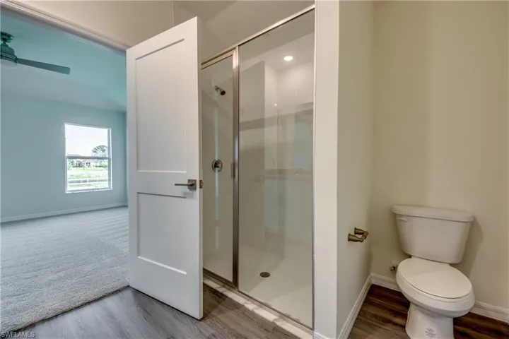 Primary bathroom - Shower is completely tiled with modern white subway tile