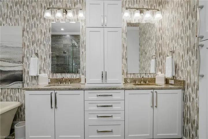 Remodeled master bath with new cabinets, lighting, countertops, sinks and plumbing