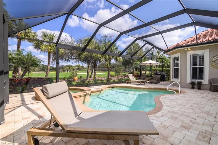 Extended lanai, new paver tile deck, heated lagoon pool and spa, lanai cage replaced with clearview picture window showcasing #6 south course fairway and green.