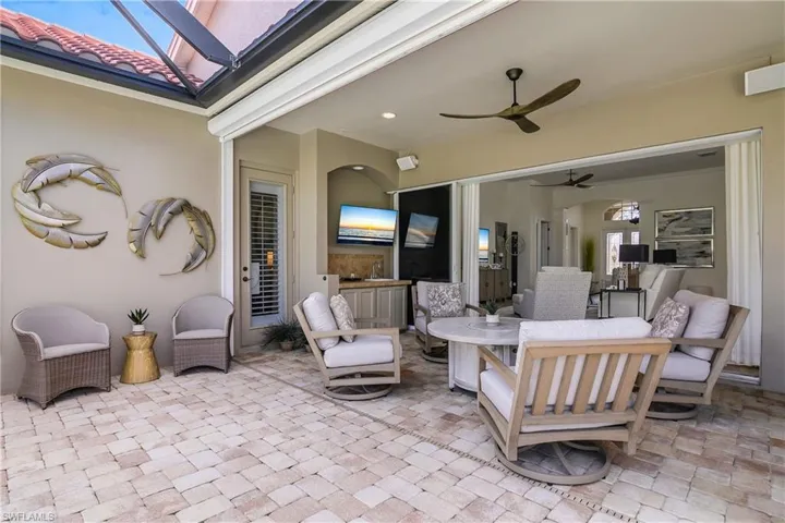 Lanai, new tile pavers, electric hurricane protection with Kevlar fabric 'see thru' shutters. Reduces wind velocity by 95%. Propane 'fire pit' in center of seating. Wet bar and TV. Door leads to master bedroom.