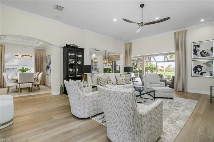 Open view from great room toward dining room, kitchen morning room and sliders to lanai.