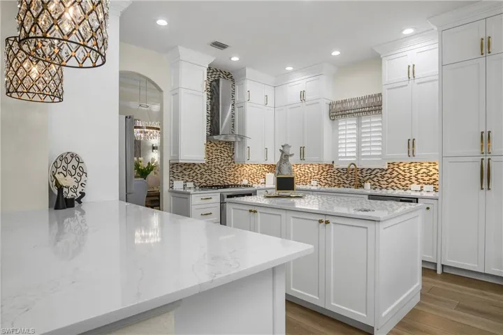 Natural gas range, new range hood, look at center island...small circle at top is to insert a wine bottle and have it thoroughly chilled in a few minutes. Plenty of storage space.
