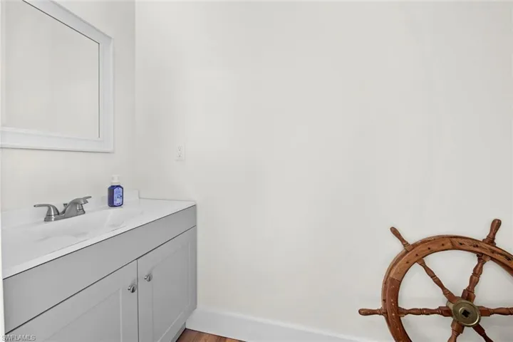 Lanai Bathroom with hardwood / wood-style floors and vanity