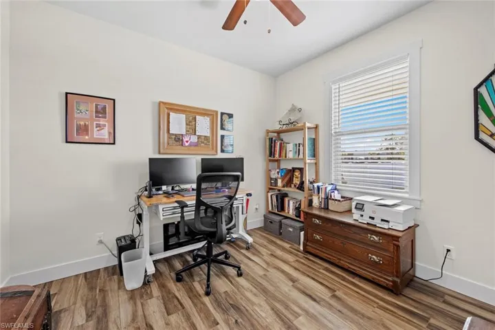 Bedroom #3 featured as an office area with ceiling fan and light hardwood / wood-style flooring