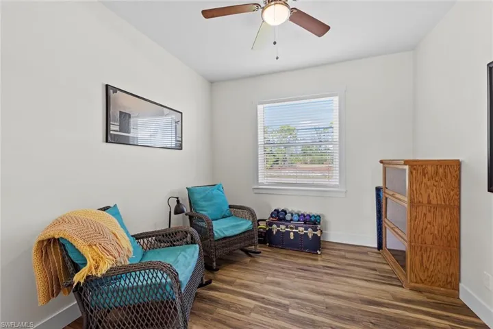 Front Den with glass doors featuring hardwood / wood-style floors and ceiling fan