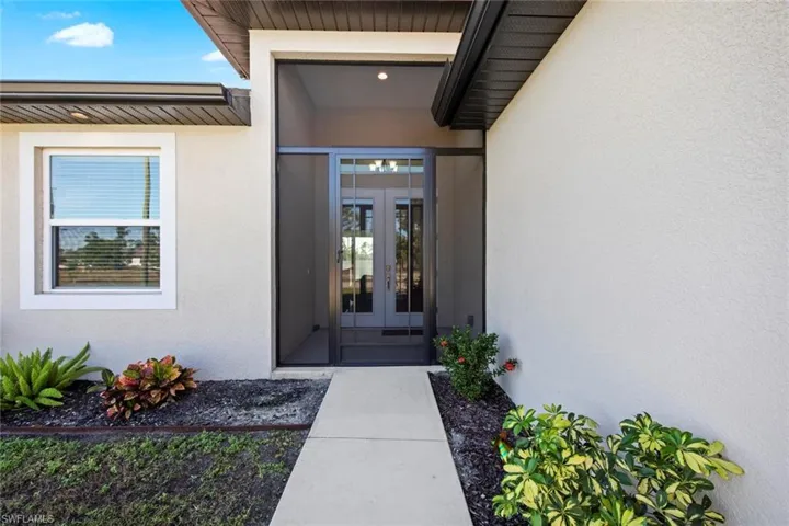 Property entrance featuring french doors