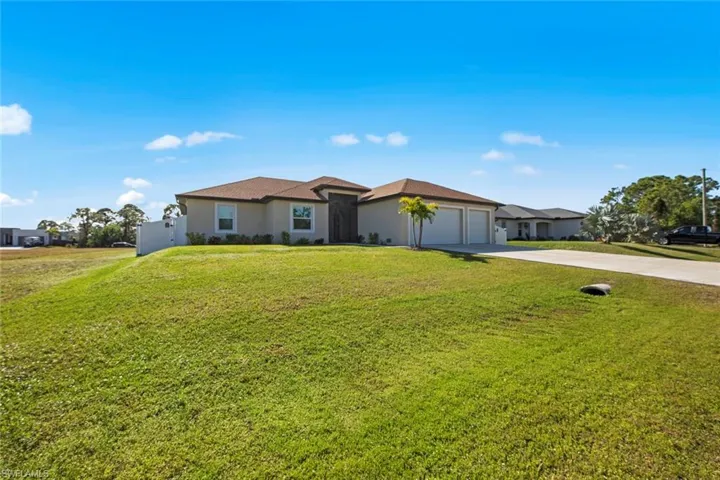 featuring a lawn and the 3-car garage