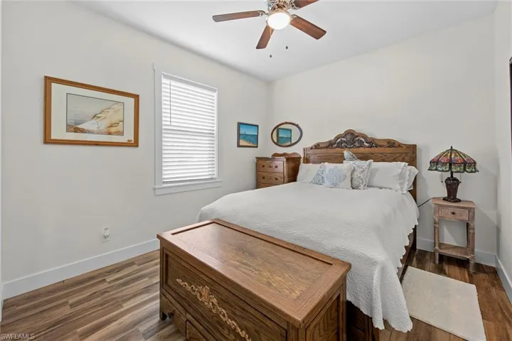 Bedroom featuring dark hardwood / wood-style floors and ceiling fan