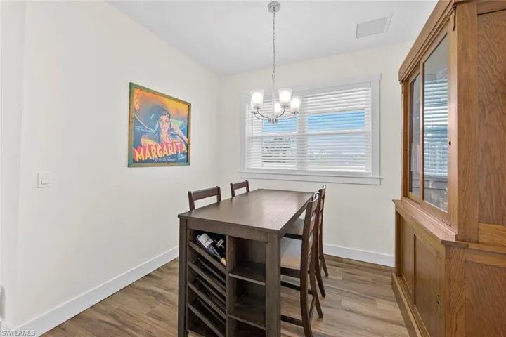 Dining space with a chandelier and hardwood / wood-style flooring