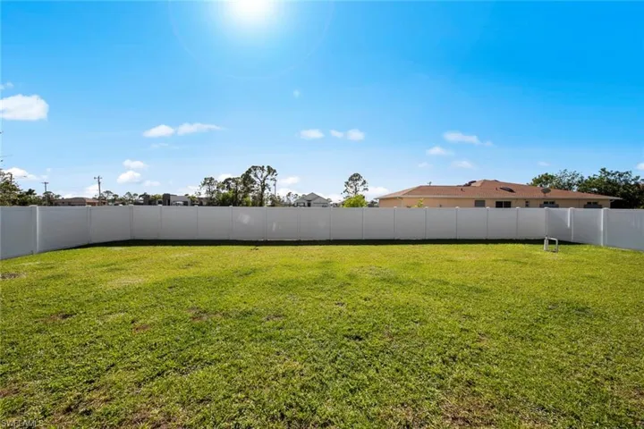 View of yard with premium vinyl fence
