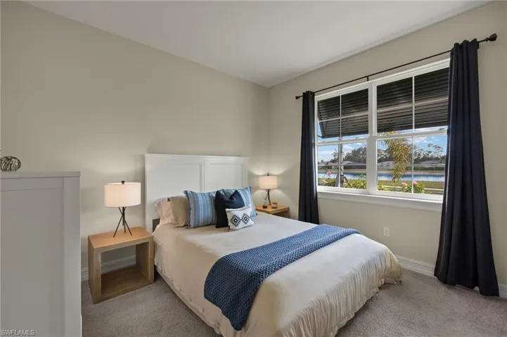 Bedroom with light colored carpet