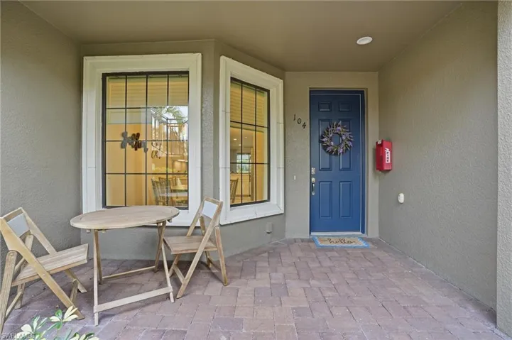 Entrance to property featuring stucco siding and a porch