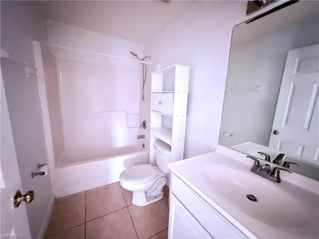 Full bath featuring vanity,  shower combination, and tile patterned flooring