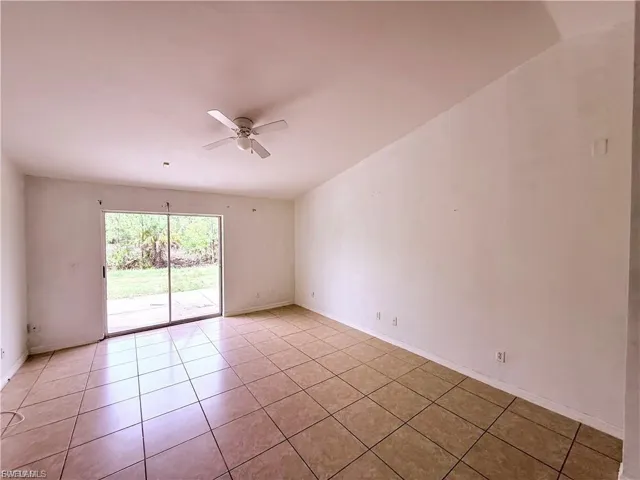 Unfurnished room featuring ceiling fan and light tile patterned flooring
