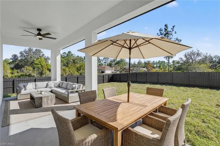 Fenced backyard featuring a patio, a ceiling fan, and outdoor lounge area