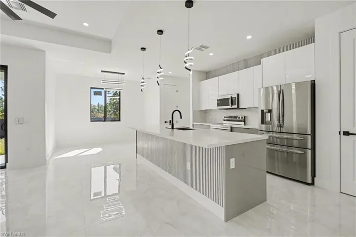Kitchen with large island and pendant lighting
