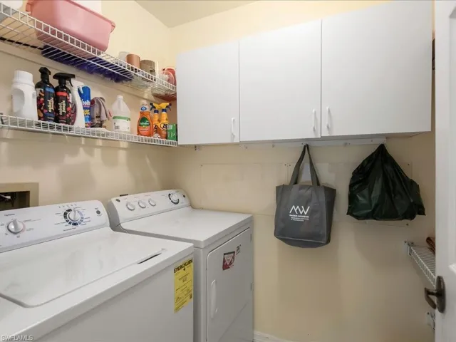 Laundry room with independent washer and dryer and cabinet space