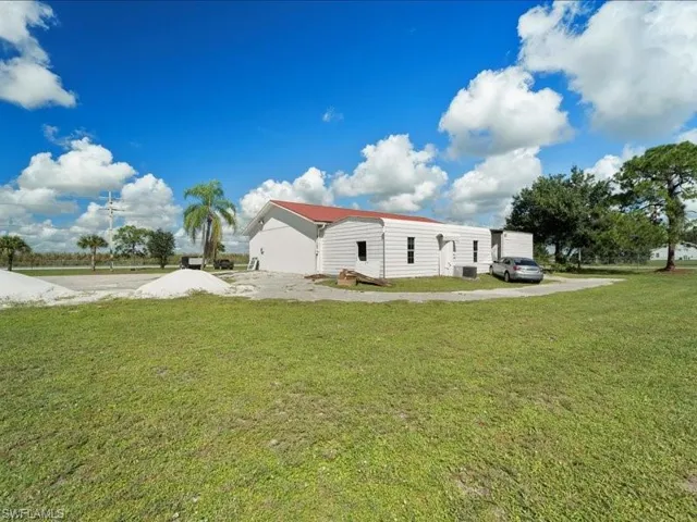 Rear view of house featuring a yard