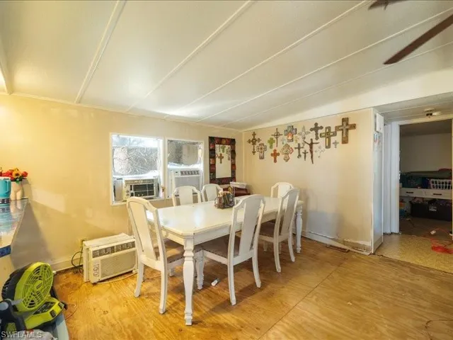 Dining area featuring cooling unit and a wall mounted air conditioner