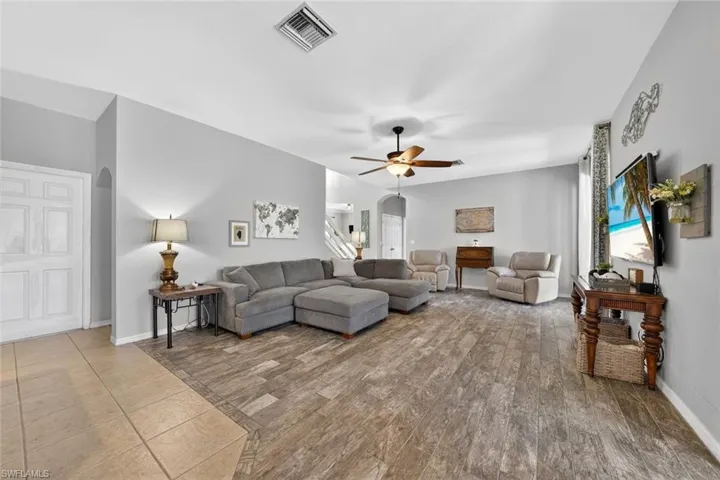 Family room with  a ceiling fan and tile floors