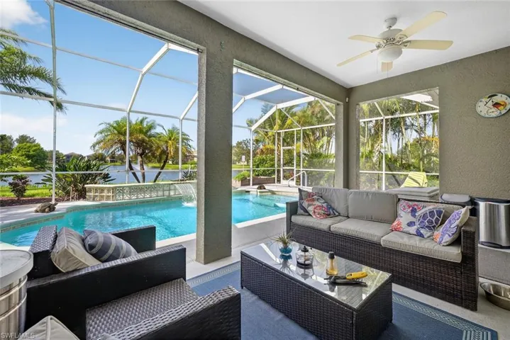 Patio featuring outdoor lounge area, a ceiling fan, and a swimming pool