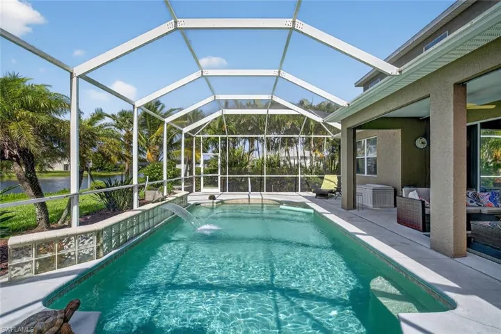 Outdoor pool featuring a water view, a patio area, and a lanai