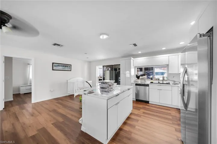 Kitchen featuring appliances with stainless steel finishes, modern cabinets, wood finished floors, and recessed lighting