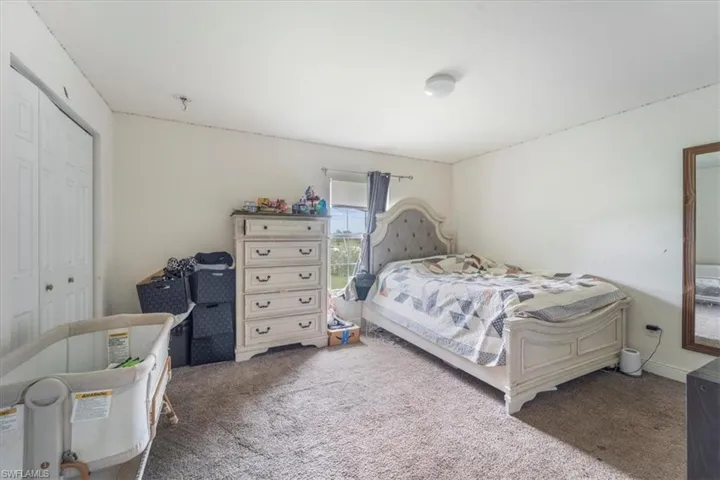 Bedroom with carpet and a closet
