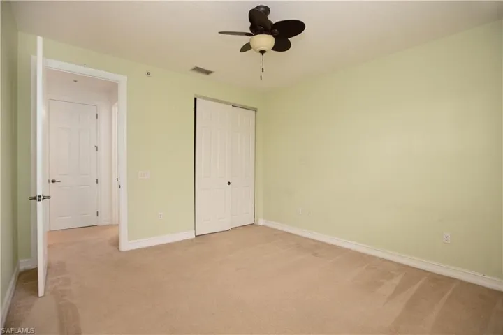 Unfurnished bedroom featuring a closet, carpet, and ceiling fan