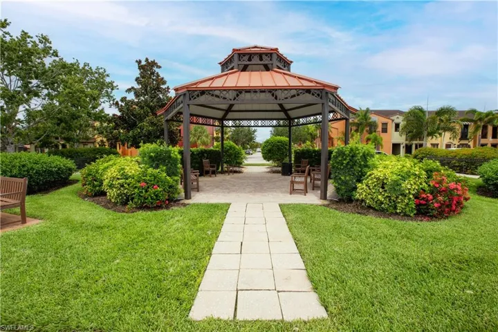 View of property's community with a patio area, a lawn, and a gazebo
