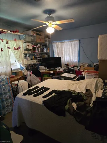 Bedroom featuring multiple windows and ceiling fan
